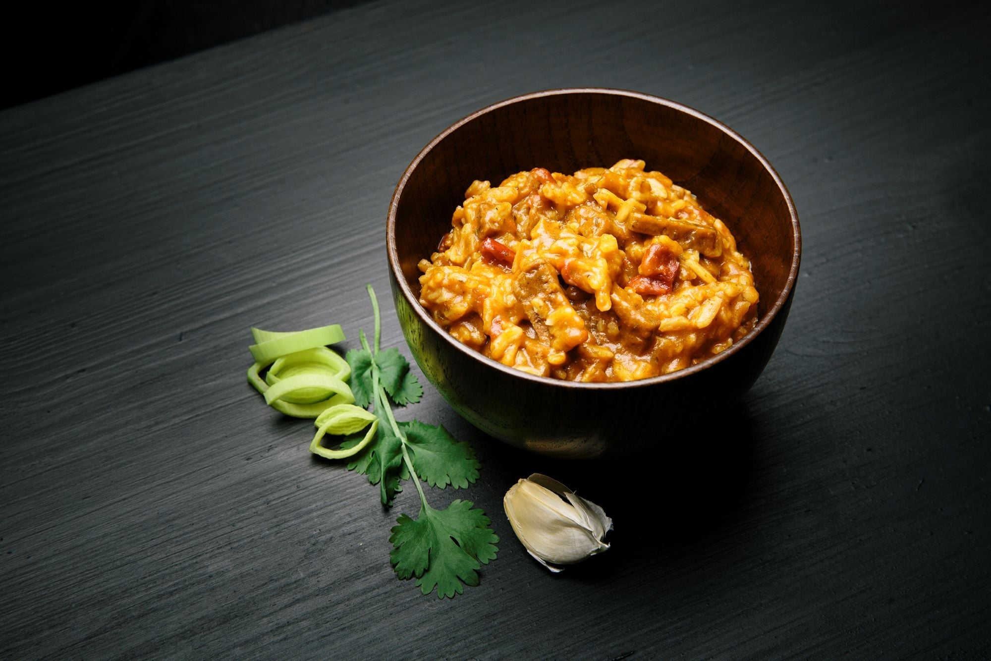 Bowl of Real Turmat Kebab Stew
with garnishes on a dark surface