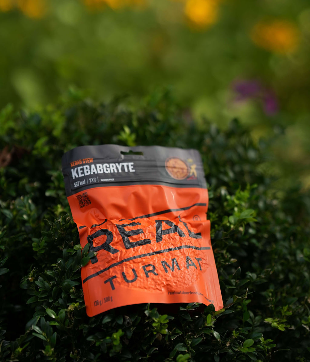 Orange package  Real Turmat Kebab Stew  on a green leafy background