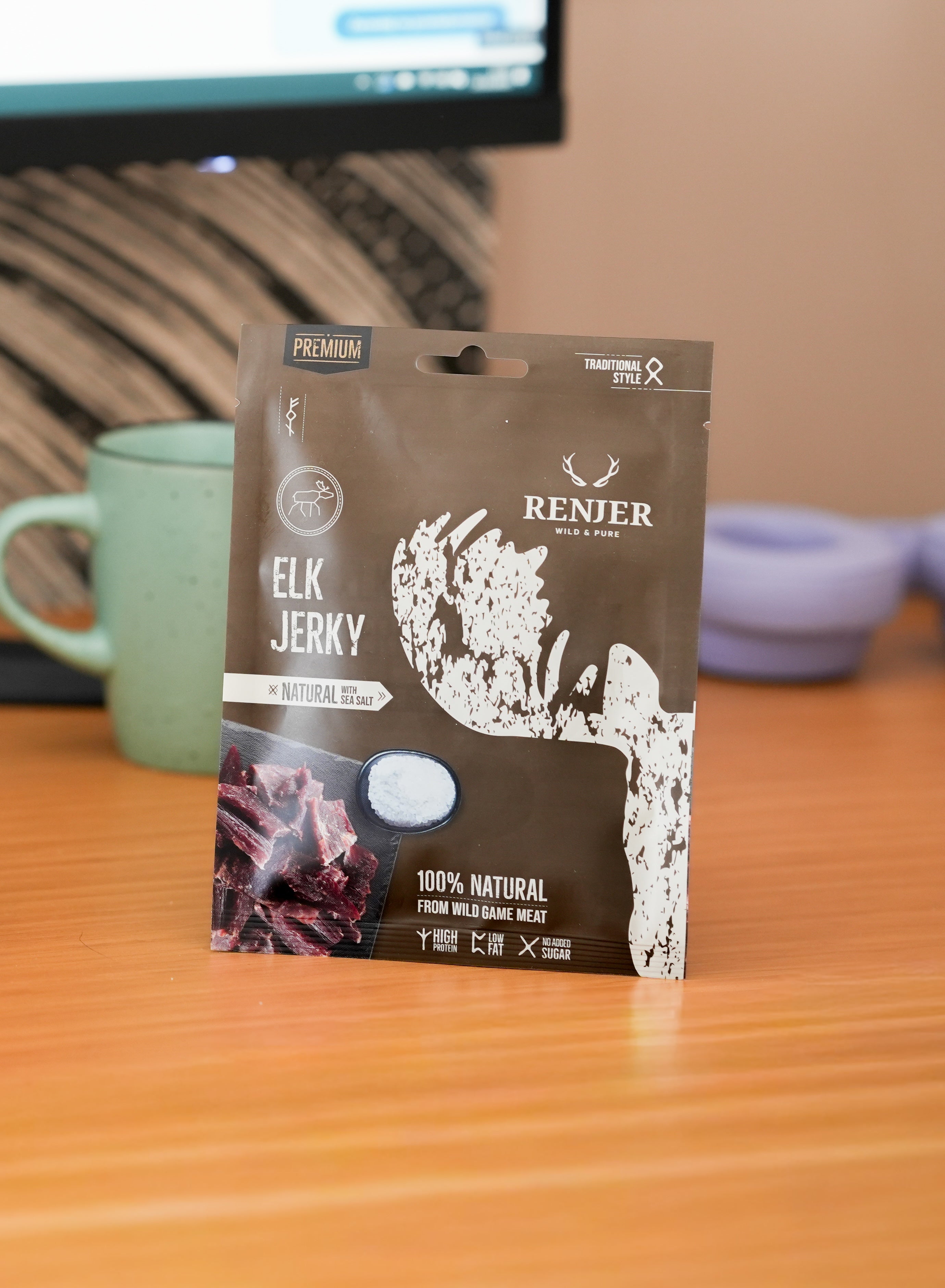 Renier elk jerky package on a table with a blurred background