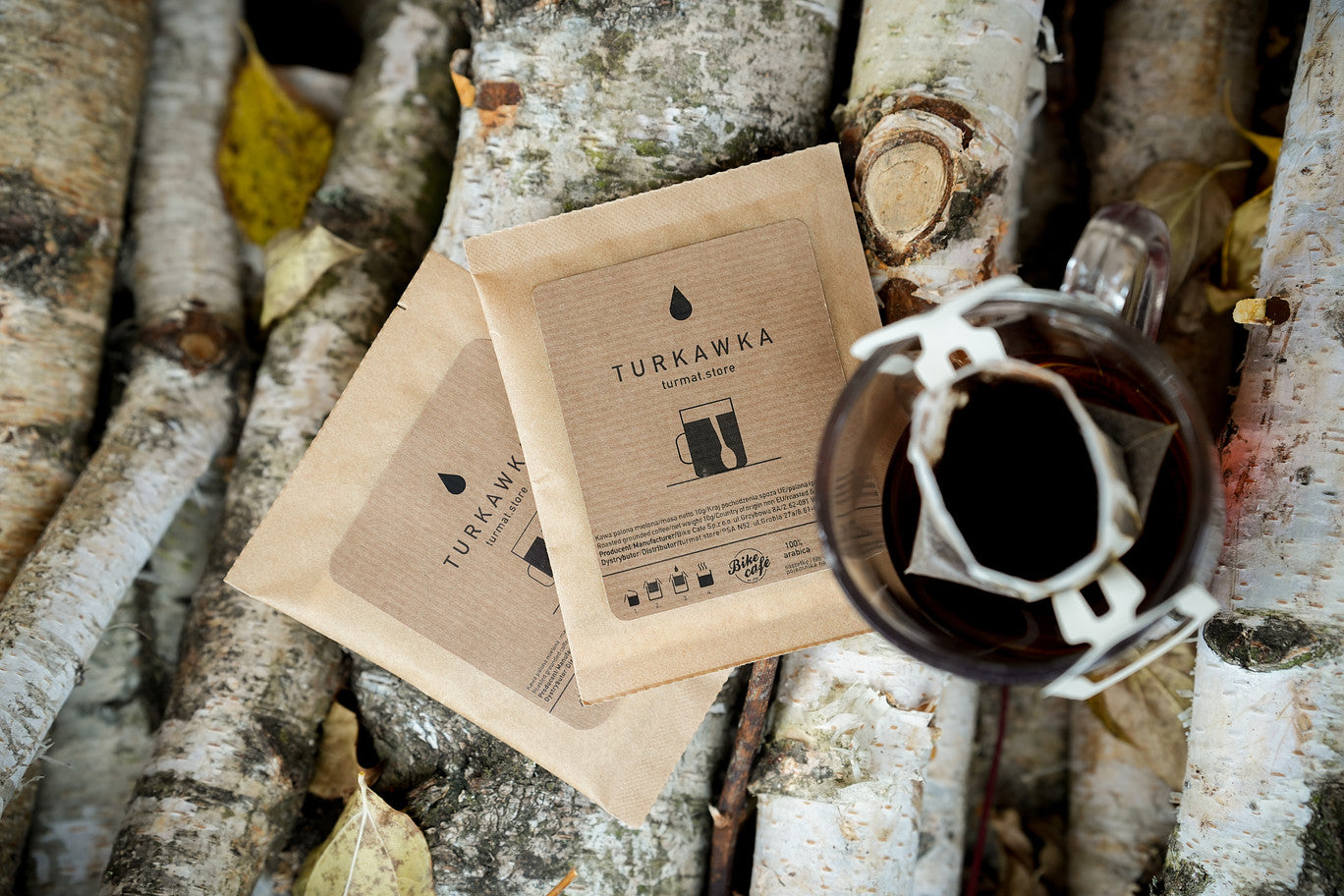 Turkawka coffee packaging and a cup of coffee on birch branches