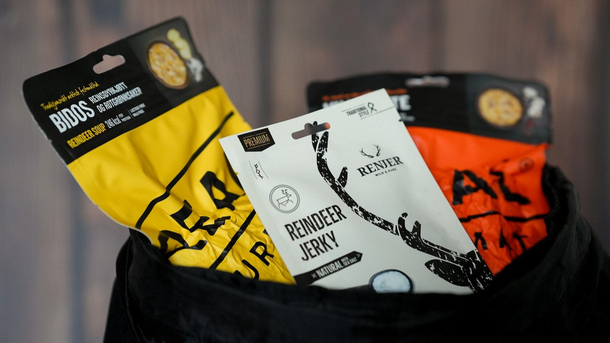 Three packages of reindeer jerky, real turmat bidos soup an realturmat reindeer stew on a blurred background