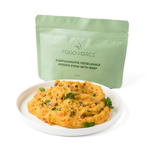 Plate of potato stew with beef next to a green 'Food Force' package on a white background