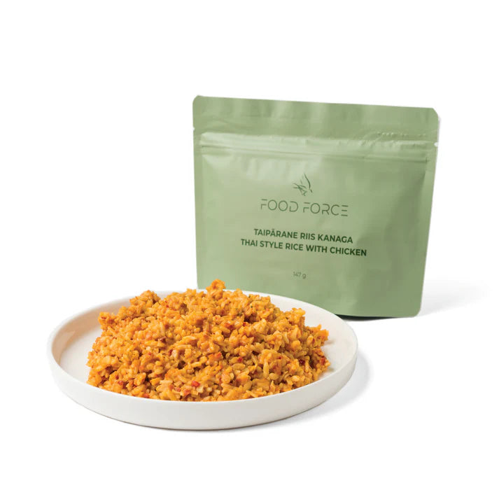 Food Force Thai Style Rice with Chicken served on a plate with pouch in the background
